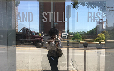 photo of Sharon reflected in storefront window